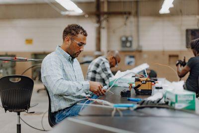 A technician on a working table working with new fiber optic