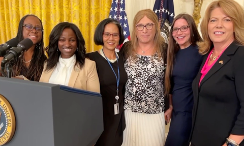 A group of ladies by a podium.