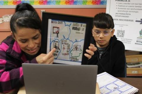 Two people showing off their artwork